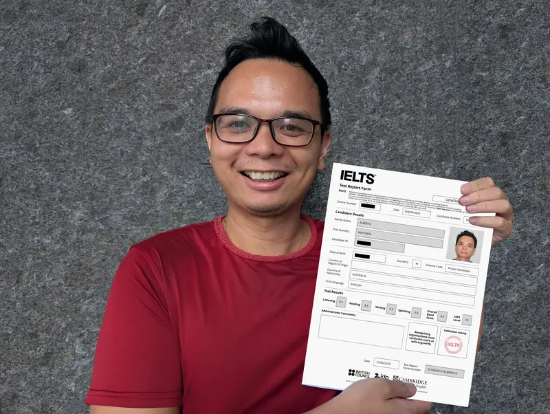 Matt holding his official IELTS Band 9 Certificate