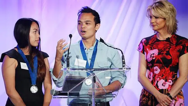 Phuong Nguyen (left) and Matthew Alberto (centre) receiving the Pride of Australia Medal, presented by Australian news presenter Sandra Sully